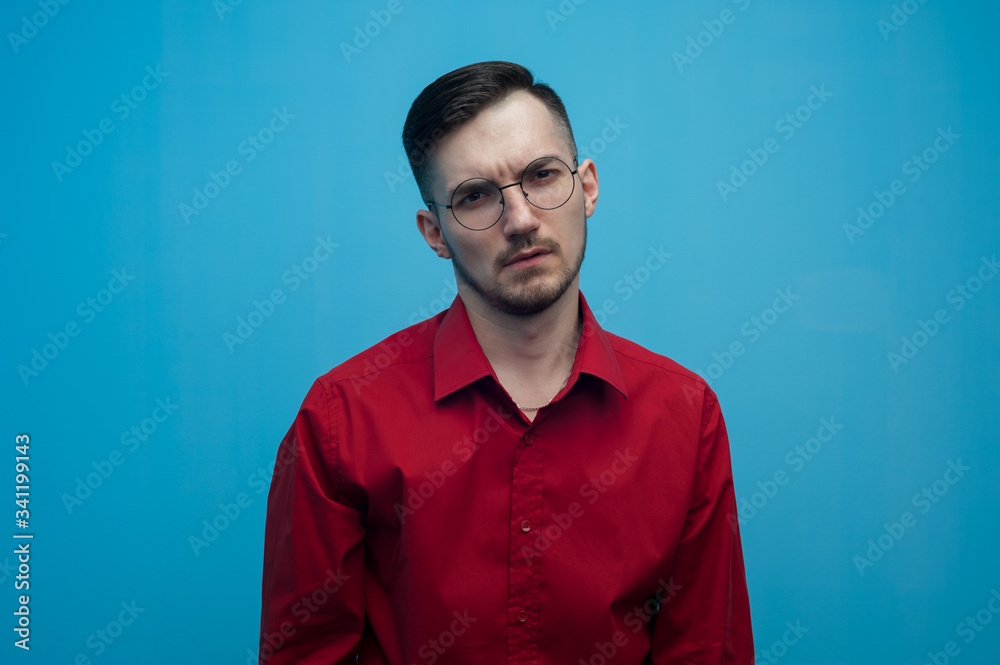 Young man in glasses and a burgundy shirt Young man in glasses and a burgundy shirt