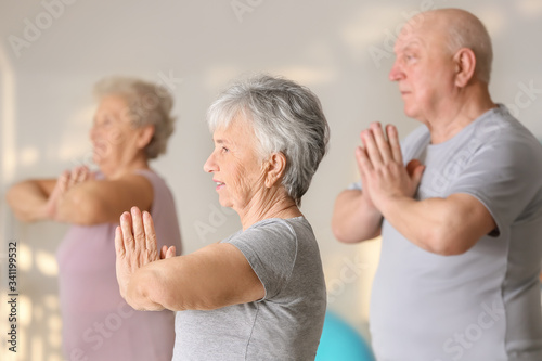 Elderly woman exercising in gym