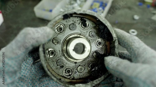 mechanic wathing broken automobile ball bearings housing