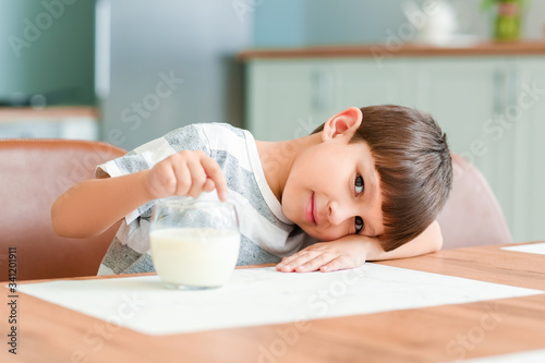 Little boy with milk in kit...