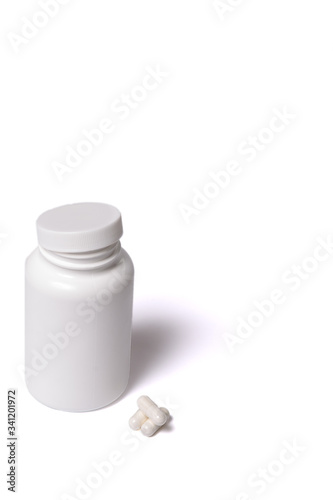 Container with capsules. White box and tabllets isolated on a white.