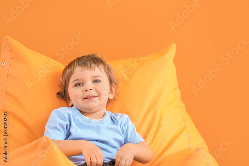 Cute little boy on color ba...
