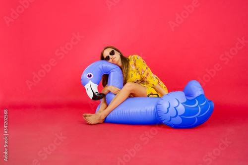 Beautiful woman enjoying leisure time on flamingo float