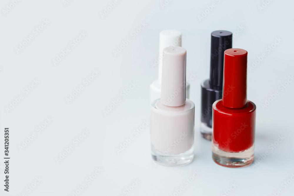Nail polish of different colors on a light gray background Nail polish of different colors on a light gray background