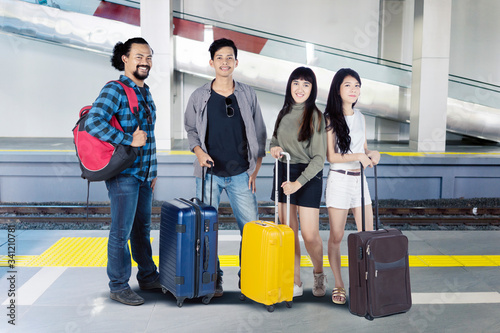 Group of young tourists standing in train station
