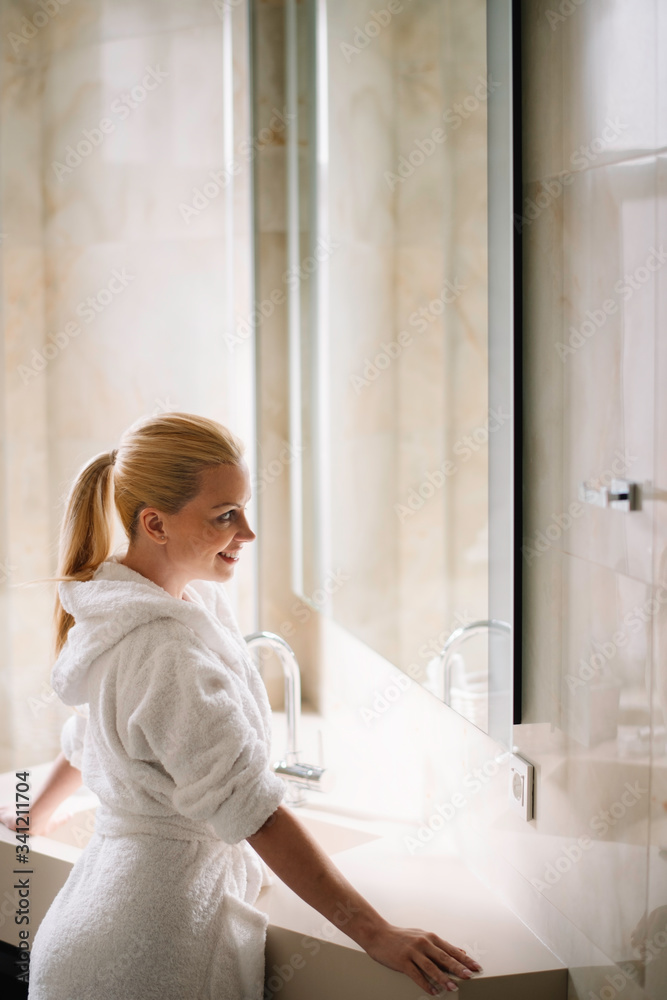 Young woman in bathrobe use the cream for the body. Beautiful woman enjoying in hotel.
Young woman in bathrobe use the cream for the body. Beautiful woman enjoying in hotel.