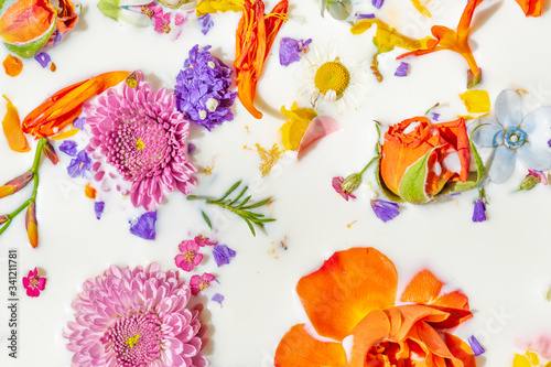 Fototapeta Naklejka Na Ścianę i Meble -  Colorful summer flowers in a milk bath background