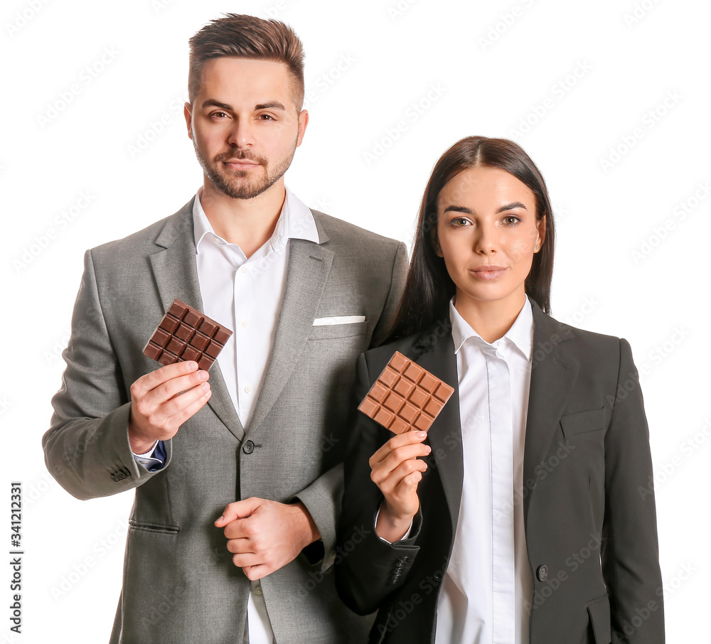 Beautiful young couple with tasty chocolate on white background Beautiful young couple with tasty chocolate on white background