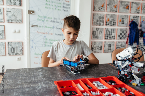 Konstfotografi Child plays with a robotic toy assembled from the designer