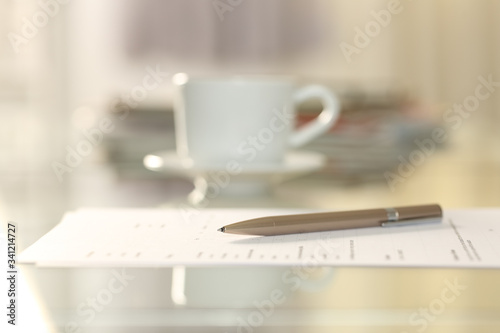 Form document on a desk with pen above