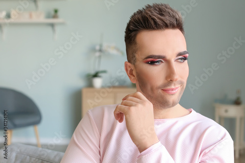 Portrait of young transgender woman at home photo