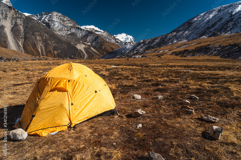 Yellow tent at Kongma Dingma campsite between Mera peak and Amphulapcha high pass, Himalaya mountains range in Nepal