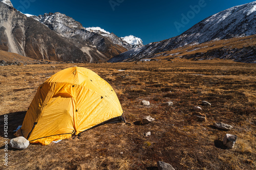 Yellow tent at Kongma Dingma campsite between Mera peak and Amphulapcha high pass, Himalaya mountains range in Nepal photo