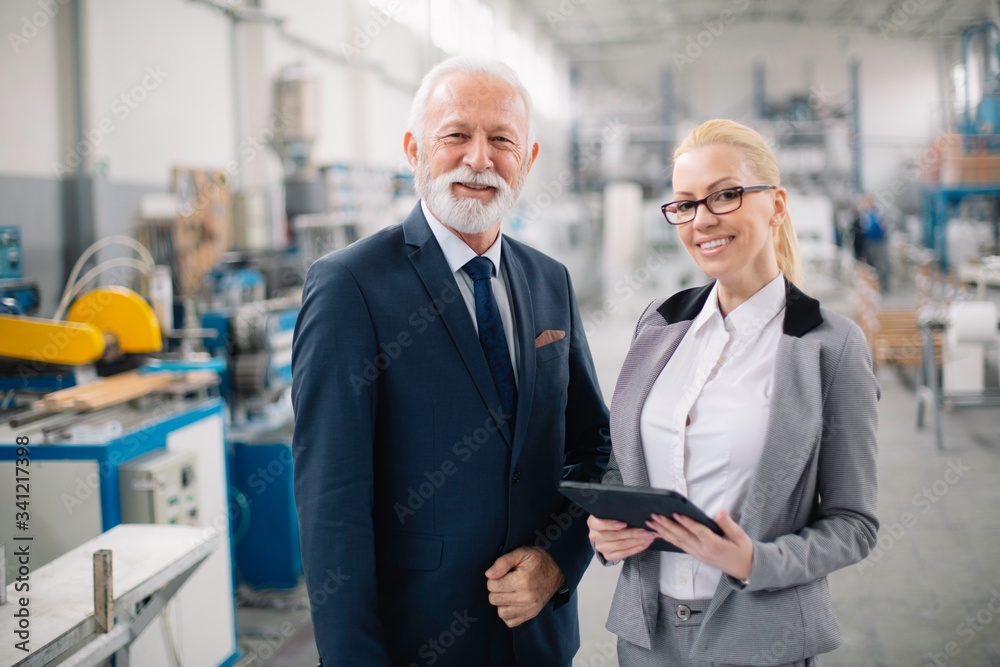 Colleagues working on project. Team of architects discussing business in factory. Colleagues working on project. Team of architects discussing business in factory.