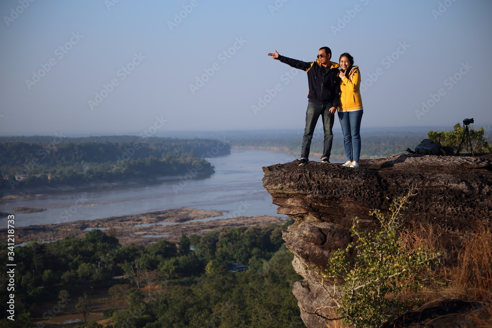 Obraz premium Women and men enjoy the view at Pha Taem National Park, Ubon Ratchathani, Thailand
