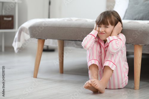 Sad little girl at home. Co...