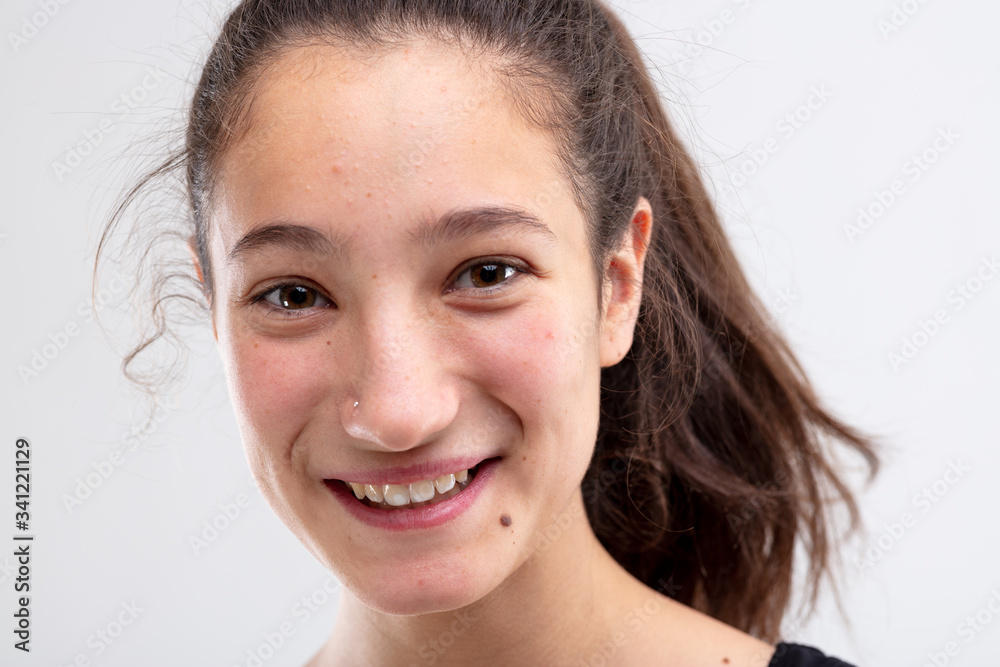 Cheerful young woman grinning at the camera Cheerful young woman grinning at the camera