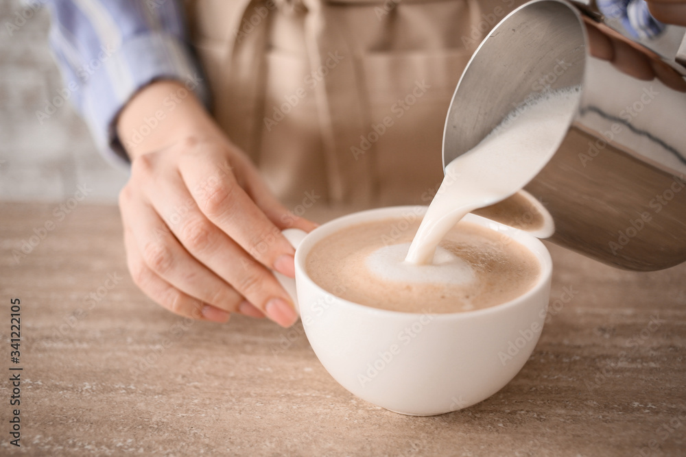 Barista preparing tasty cappuccino in cafe, closeup Barista preparing tasty cappuccino in cafe, closeup