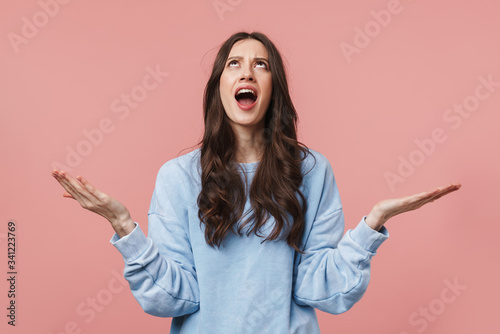 Image of displeased brunette woman screaming and throwing up her arms