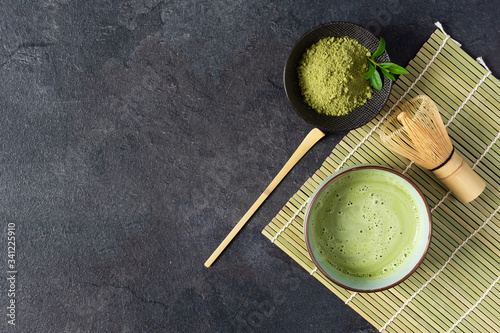 Konstfotografi Green matcha tea drink and tea accessories on black background top view