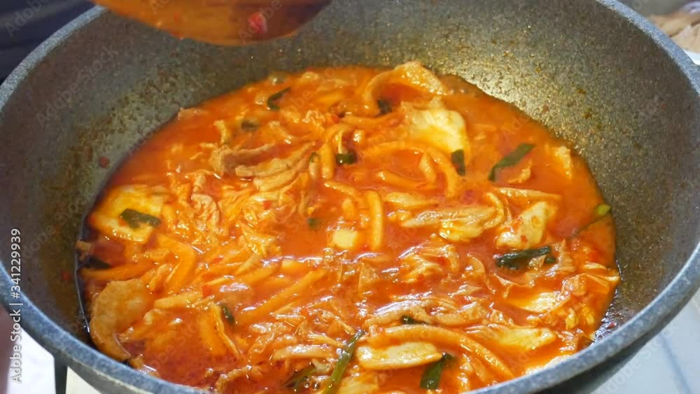 POV to pan while cooking korean food-Soft tofu stew/sundubu-jjigae. Korean home cooking-soft tofu soup with kimchi. POV to pan while cooking korean food-Soft tofu stew/sundubu-jjigae. Korean home cooking-soft tofu soup with kimchi.