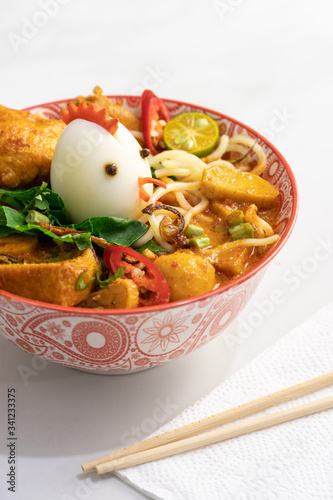 traditional curry mee in decorated bowl white background photo