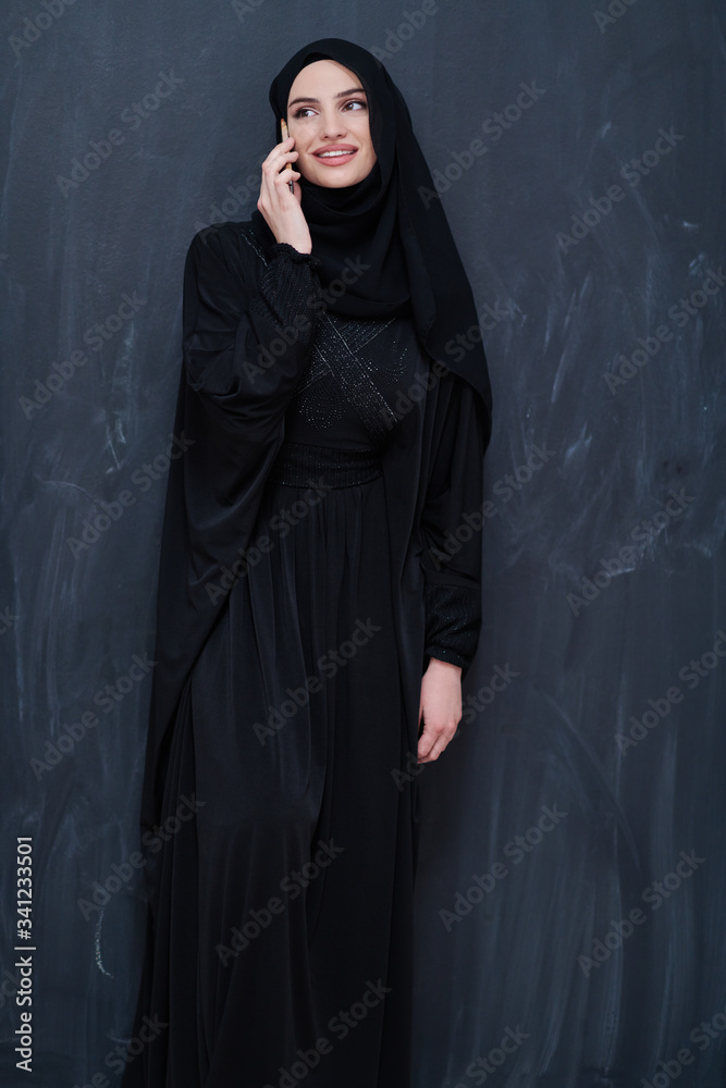 young modern muslim business woman using smartphone young modern muslim business woman using smartphone