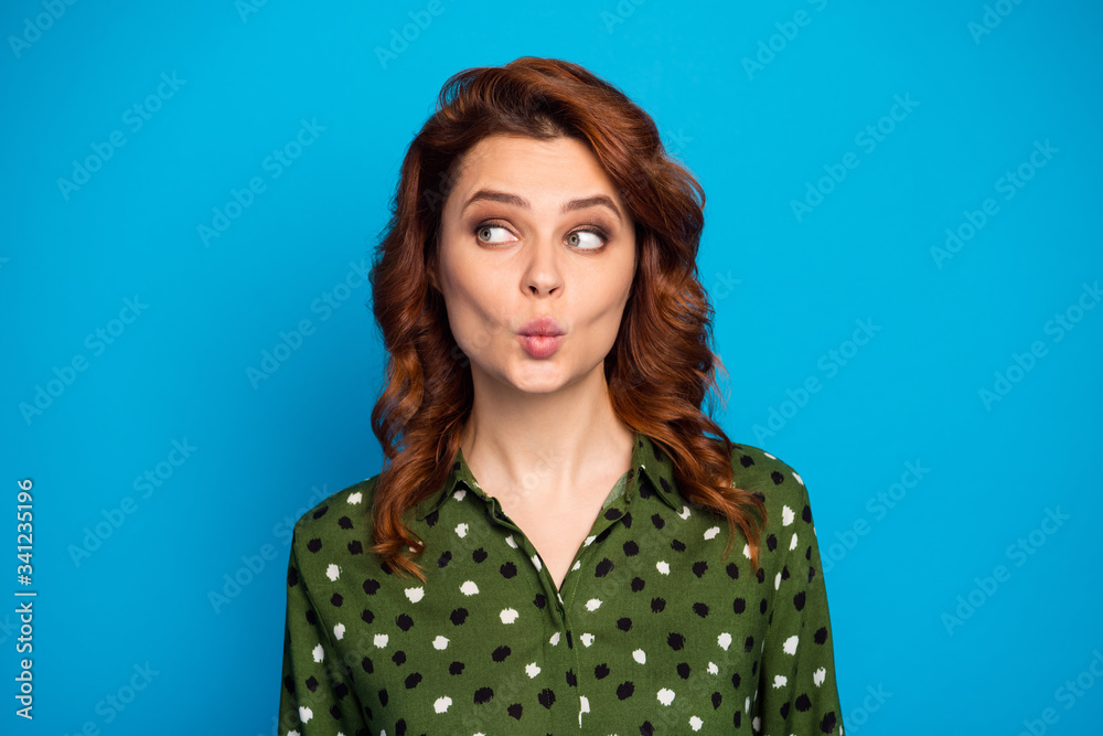 Closeup photo of pretty curly lady look interested side empty space shy sending air kisses handsome guy wear green dotted office shirt isolated bright blue color background Closeup photo of pretty curly lady look interested side empty space shy sending air kisses handsome guy wear green dotted office shirt isolated bright blue color background