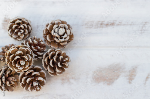Dried pine balls on a white vintage wooden