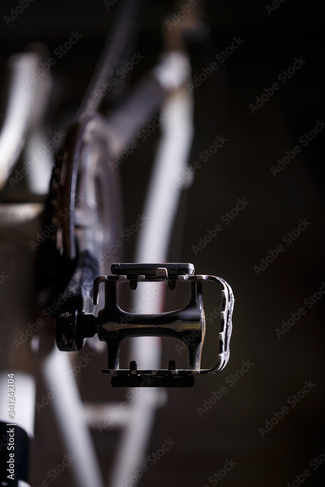 Black metal pedal on a bike with hard light. Bike accessories Black metal pedal on a bike with hard light. Bike accessories