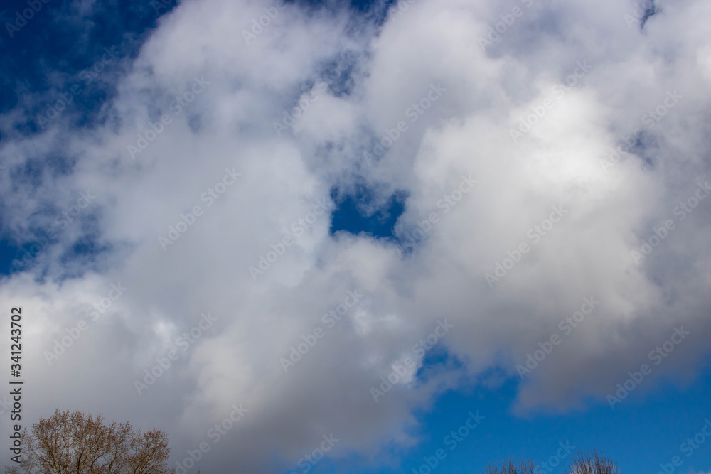 Beautiful blue sky with white clouds. Spring weather.