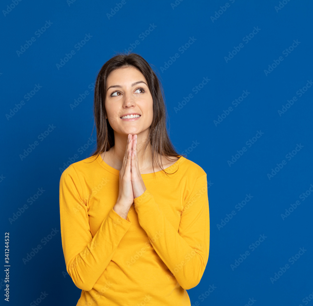 Brunette young woman wearing a yellow T-shirt Brunette young woman wearing a yellow T-shirt