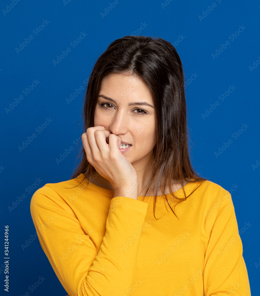 Brunette young woman wearing a yellow T-shirt Brunette young woman wearing a yellow T-shirt