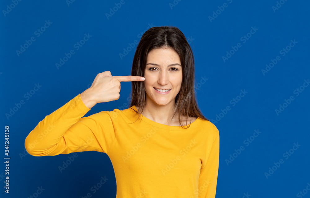 Brunette young woman wearing a yellow T-shirt Brunette young woman wearing a yellow T-shirt