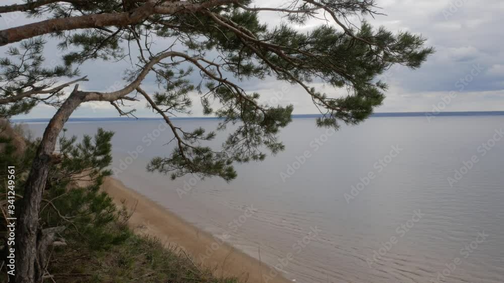 A long sandy shore is visible on a large river from a high cliff A long sandy shore is visible on a large river from a high cliff