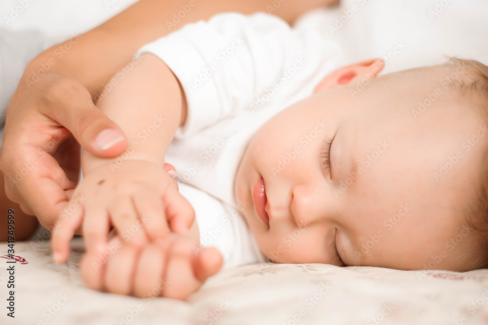Little boy lies near his mom resting on the bed. Little boy lies near his mom resting on the bed.