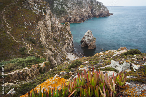 Rock cliffs by the sea at Beach Lourical on Cabo da Roca, Sintra, Portugal photo