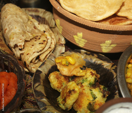 chole tikiya, fried potato,chapatti served in disposable plate
