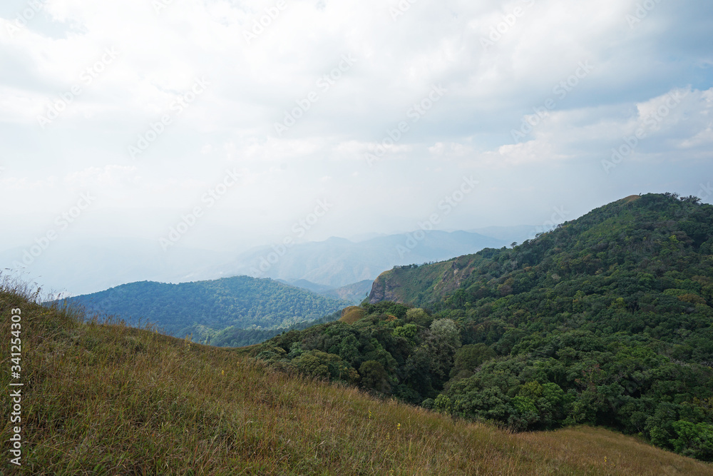 Fototapeta premium Natural landscape of green mountain range with cloudy blue sky