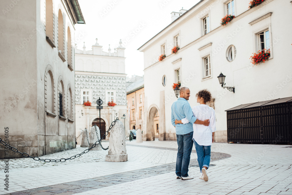 guy and a girl happily walk in the morning on the empty streets