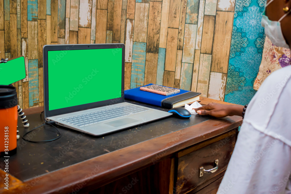 young person cleaning a laptop on the office desk against germs and bacteria young person cleaning a laptop on the office desk against germs and bacteria