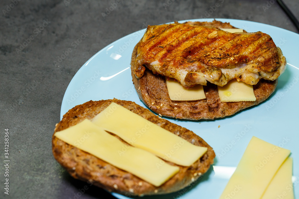 homemade hamburger with chicken, sauce and cheese fried on an electric grill homemade hamburger with chicken, sauce and cheese fried on an electric grill