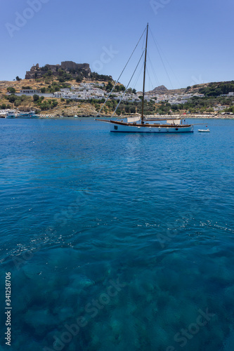 Lindos Village in Rhodes, Greece - 07/07/2018 : view of a yacht in the sea.