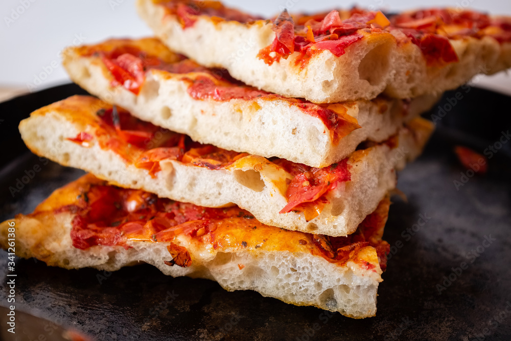 Close up of slices of delicious homemade focaccia barese bread with tomato Close up of slices of delicious homemade focaccia barese bread with tomato