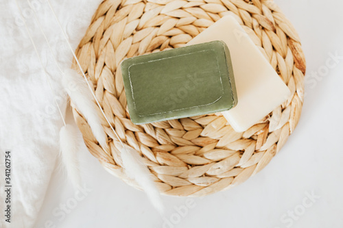 Flat lay natural handmade soap bars with grass flowers in spa compostition photo