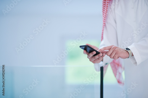 Photography young arabian businessman using smartphone at home