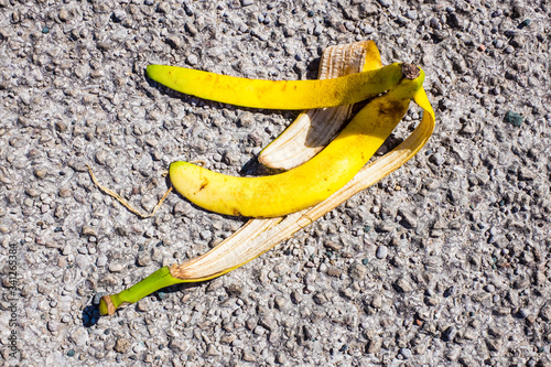 Obraz na plátne slippery banana peel laying on ground ready to make someone slip and fall