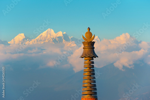 View of golden top of buddhist stupa tower with snow mountain backdrop (Nepal) photo