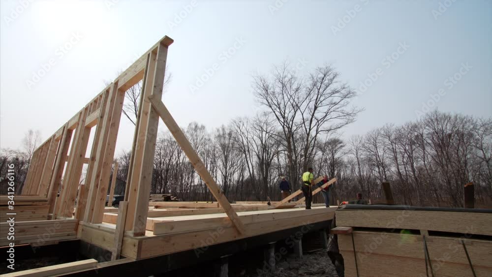 Time lapse of busy builders preparing walls harnessing for lifting. Big frame house under construction Time lapse of busy builders preparing walls harnessing for lifting. Big frame house under construction