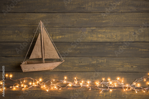 Photography Travel and adventure creative concept - toy boat on a wooden background